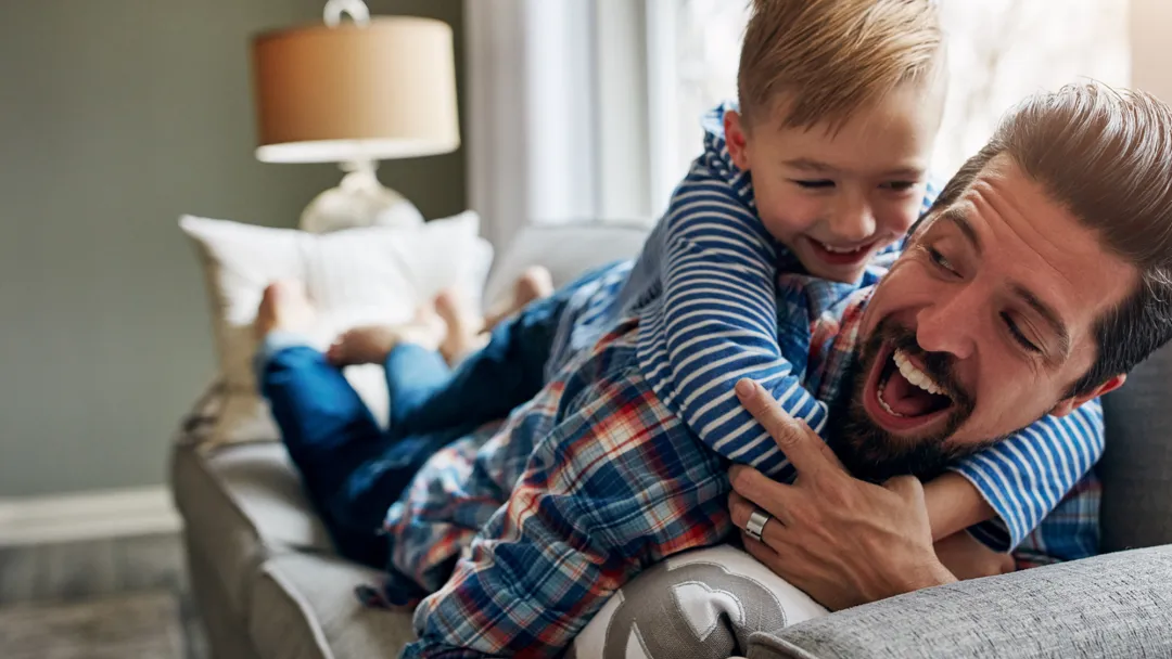 Son Hugging Father on Couch