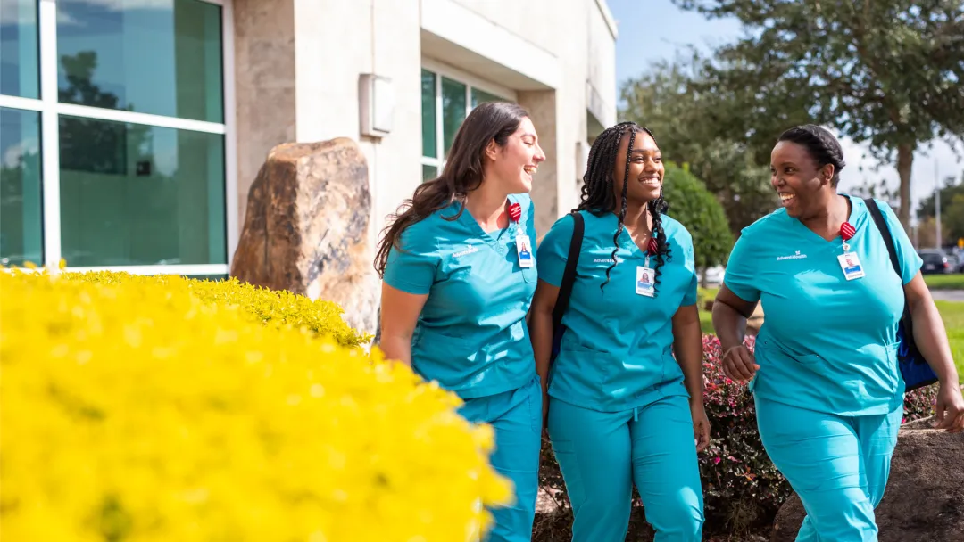 3 nurses walking outside a hospital