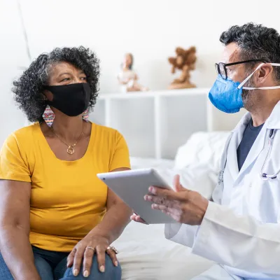 A Doctor Goes Over Details of a Case with the Patient while in an Exam Room.
