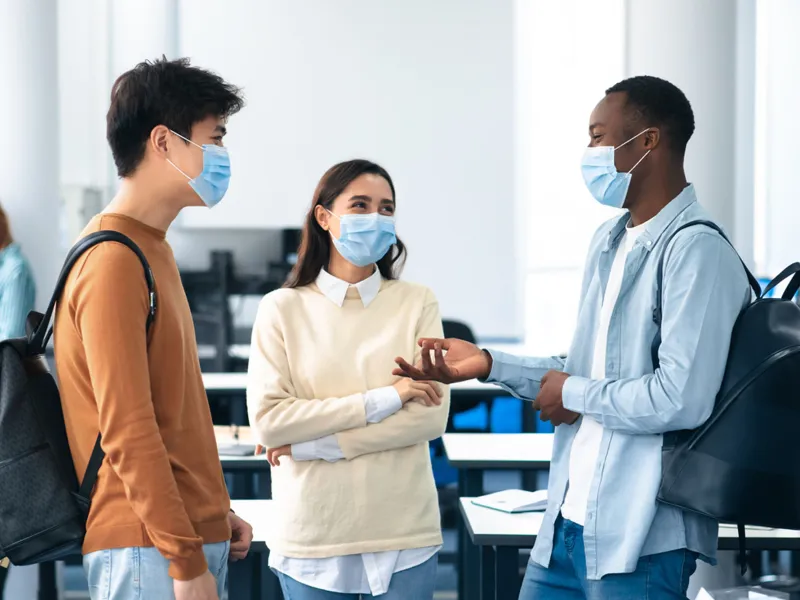 A group of students talking in their classroom