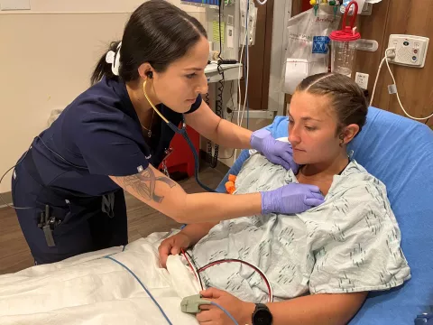 Christina Vega, RN, a recent graduate of the Lake Sumter State Dedicated Education Unit at AdventHealth Waterman treats a patient in the emergency department.
