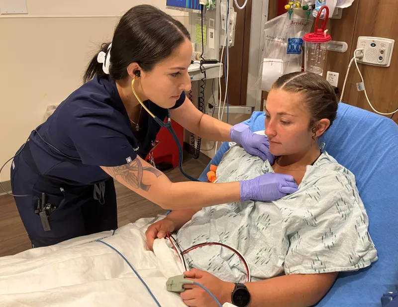 Christina Vega, RN, a recent graduate of the Lake Sumter State Dedicated Education Unit at AdventHealth Waterman treats a patient in the emergency department.